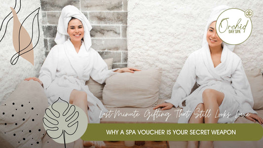 Two women relaxing in white spa robes, smiling while seated on a cozy spa lounge – the perfect moment of calm offered by couples spa packages South Africa.
