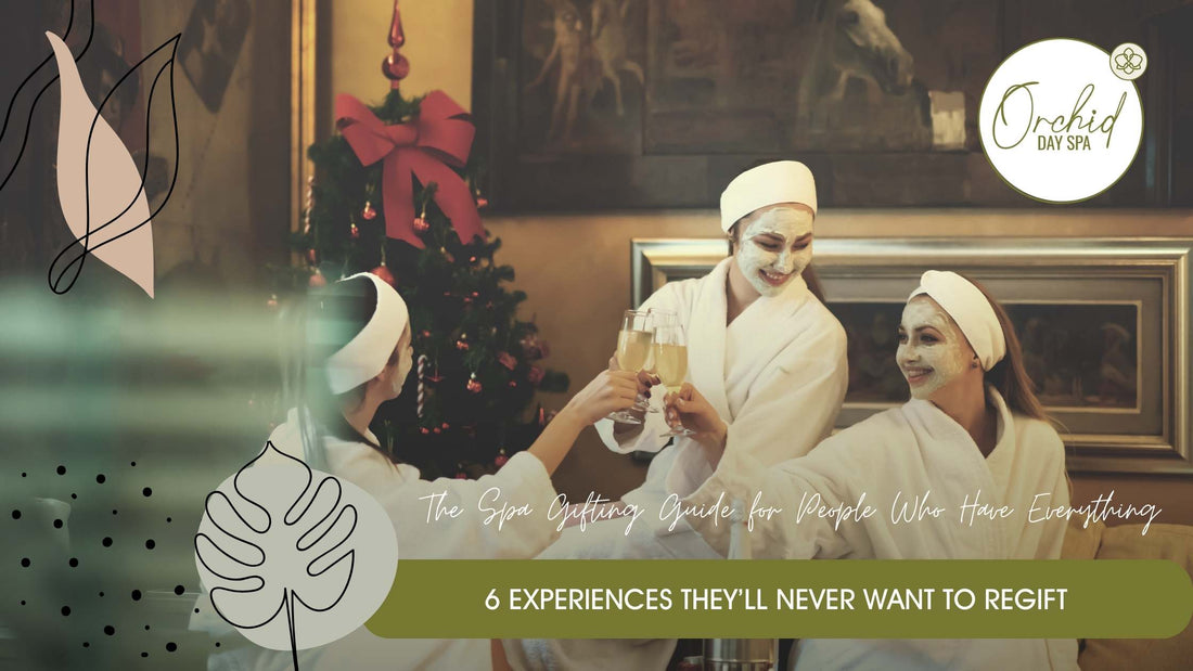 Three women in spa robes with facial masks clinking champagne glasses beside a Christmas tree – enjoying a festive spa day at Orchid Day Spa, a perfect setting for spa gift vouchers in South Africa.